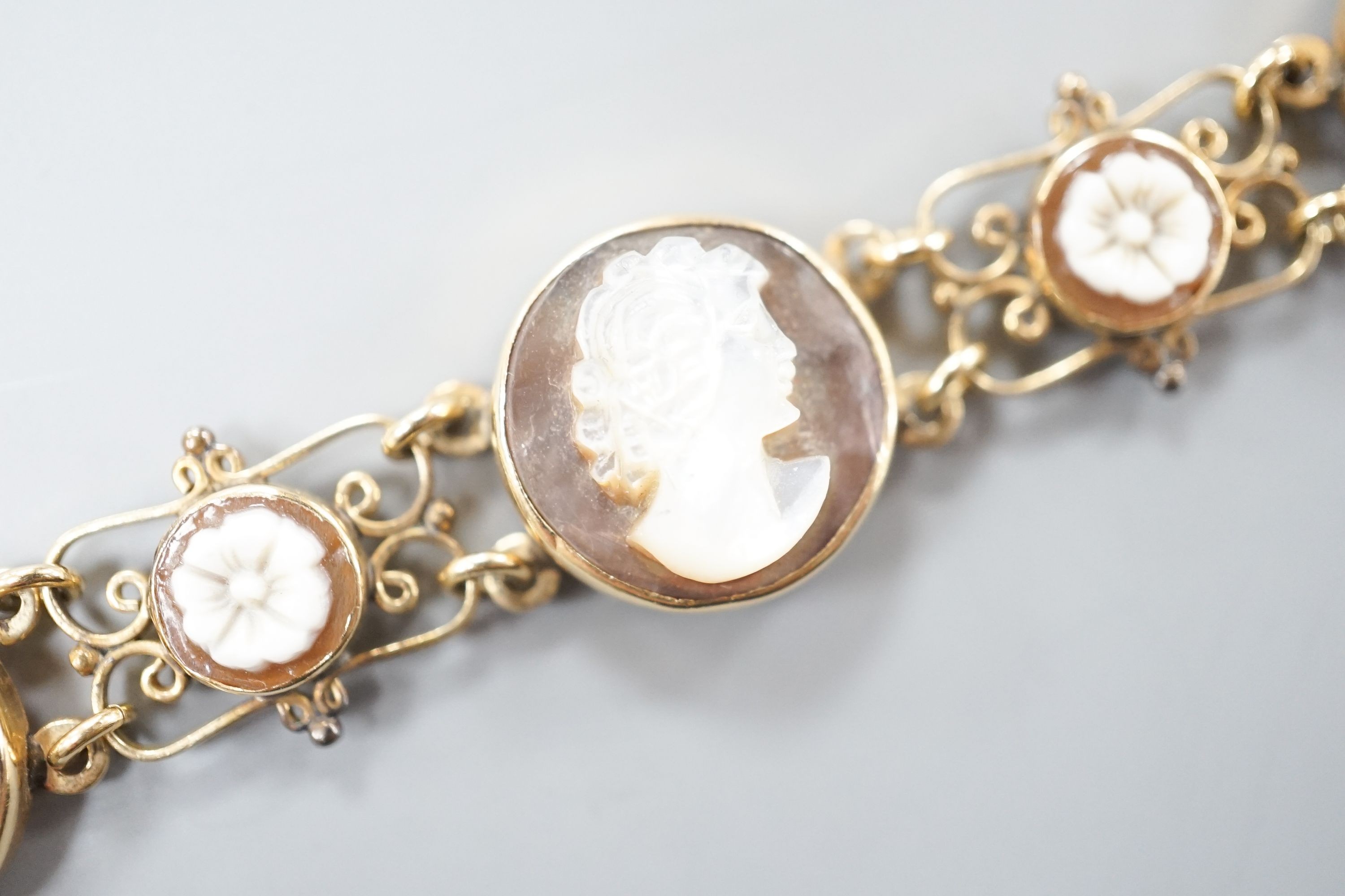 A 14k yellow metal gold Neapolitan shell and coral cameo set bracelet, 16.3cm, gross weight 13.4 grams.